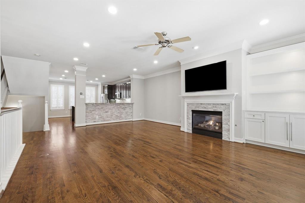 Spacious 2nd floor living room.  Wood floor, built-ins and gas fireplace