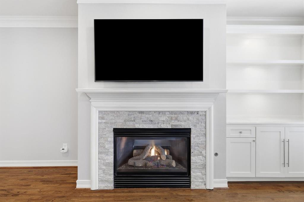 2615 Colby Street, Unit B Dallas, TX 75204 - Photo 11 of 39 2nd floor living room with stone and gas fireplace, built in shelving and cabinets. TV stays