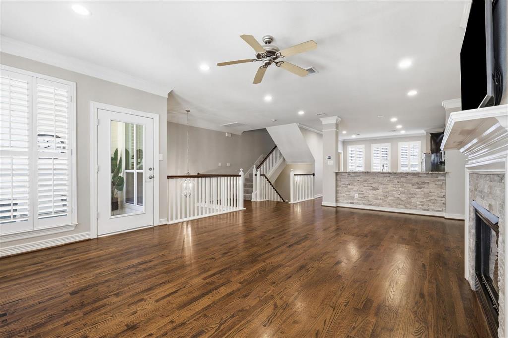2615 Colby Street, Unit B Dallas, TX 75204 - Photo 13 of 39 2nd floor living room / dining room combo showing open stairwell and door to covered patio