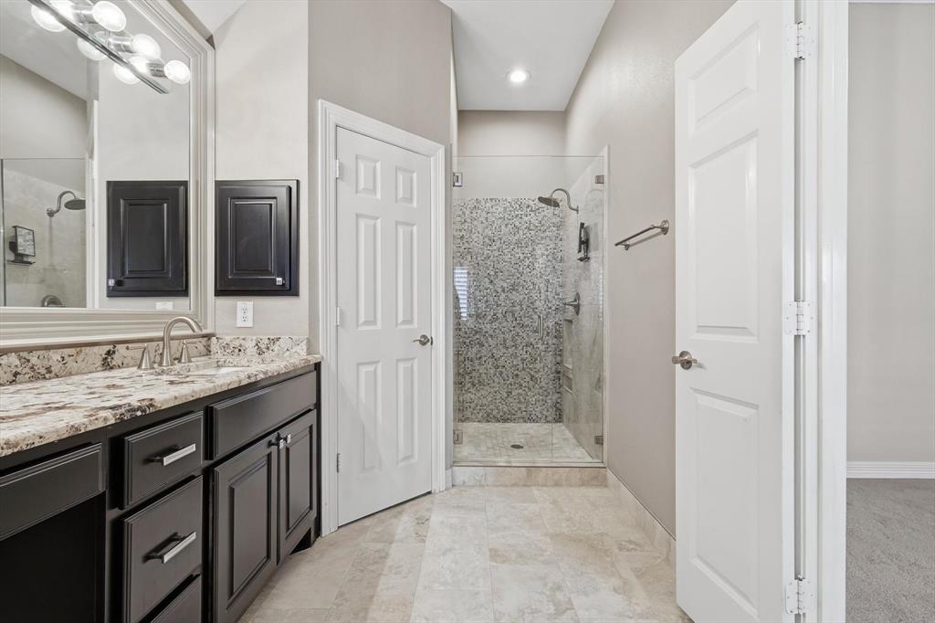 2615 Colby Street, Unit B Dallas, TX 75204 - Photo 22 of 39 Primary bathroom with vanity and a stall shower