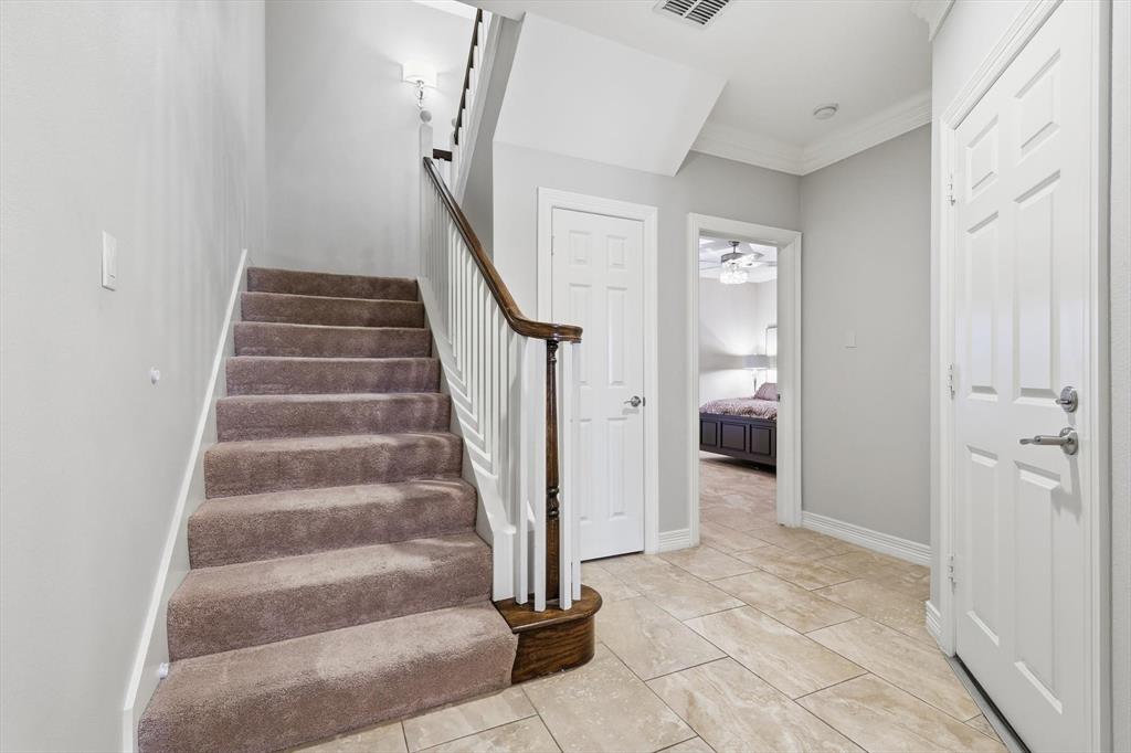 2615 Colby Street, Unit B Dallas, TX 75204 - Photo 5 of 39 entry level staircase, showing carpet, tile and downstairs bedroom