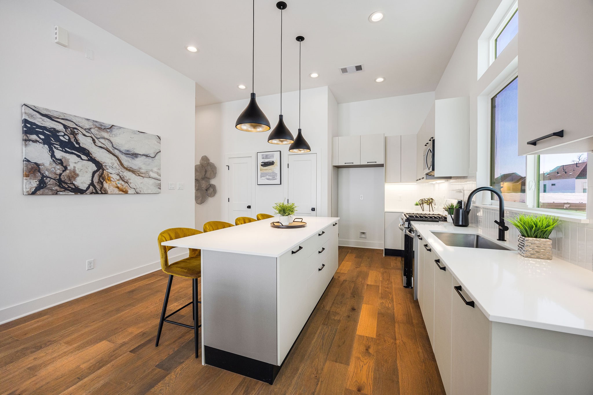 303 Marcella Street, Unit F Houston, TX 77091 - Photo 12 of 29 Sleek, modern kitchen with stainless steel appliances, elegant Italian cabinetry, soft closing cabinets/drawers, and a spacious island perfect for entertaining.