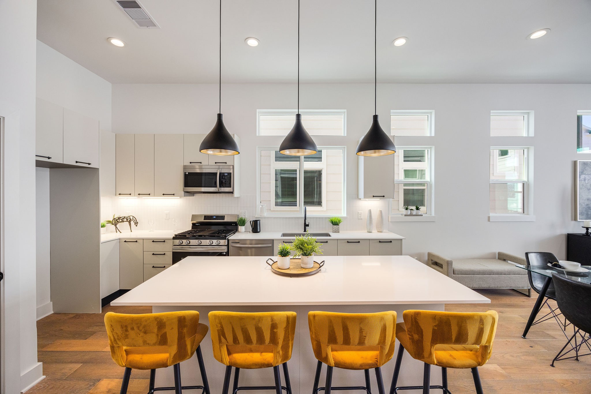 303 Marcella Street, Unit F Houston, TX 77091 - Photo 8 of 29 Sleek, modern kitchen with stainless steel appliances, elegant Italian cabinetry, soft closing cabinets/drawers, and a spacious island perfect for entertaining.