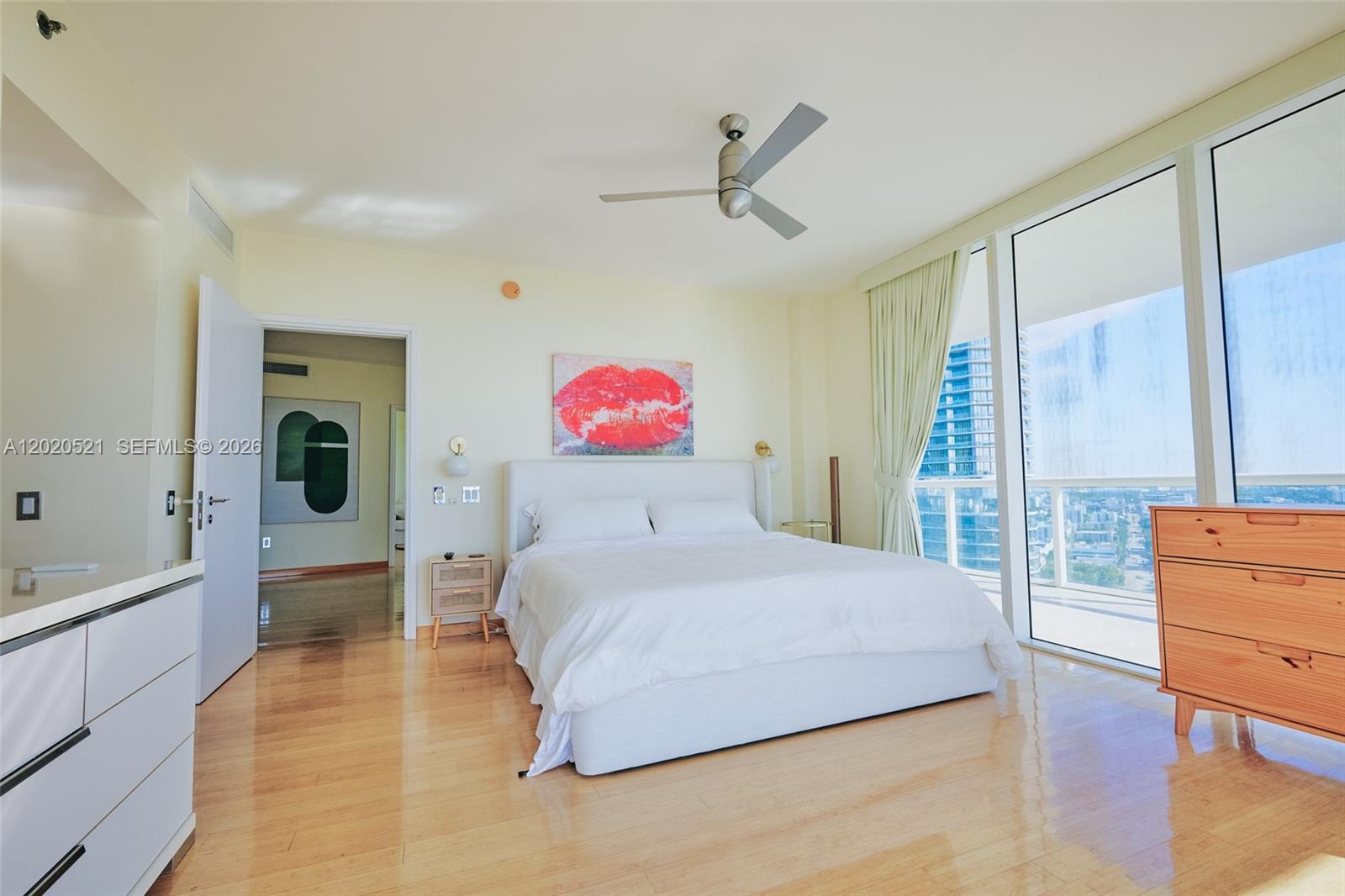 450 Alton Road, Unit 2810 Miami Beach, FL 33139 - Photo 11 of 29 a bedroom with a bed and wooden floor