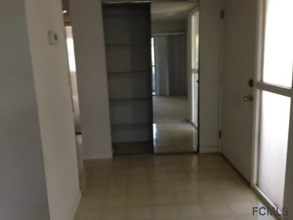view of hall way with wooden floor and closet