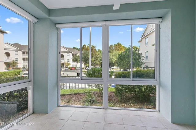 a view of a glass door with a yard