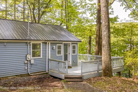 a view of balcony with wooden floor and fence