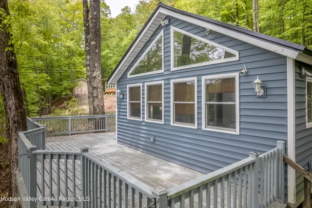 a view of a house with wooden deck and wooden floor