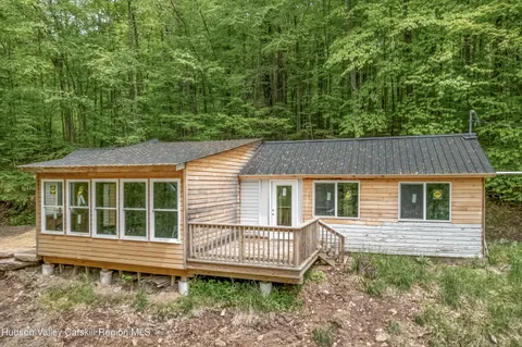 a view of water heater room with a floor to ceiling window and couch