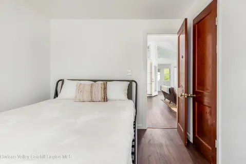 a view of a hallway with wooden floor and closet