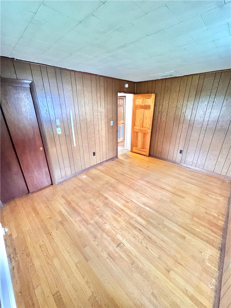 8325 Schantz Road Breinigsville, PA 18031 - Photo 13 of 21 Original hardwood floors extend through this bedroom with classic wood paneling.