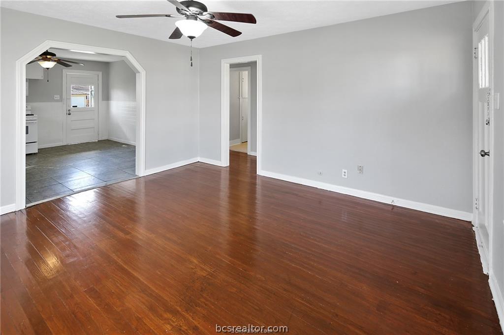 1504 Baker Avenue Bryan, TX 77803 - Photo 3 of 17 an empty room with wooden floor and ceiling fan