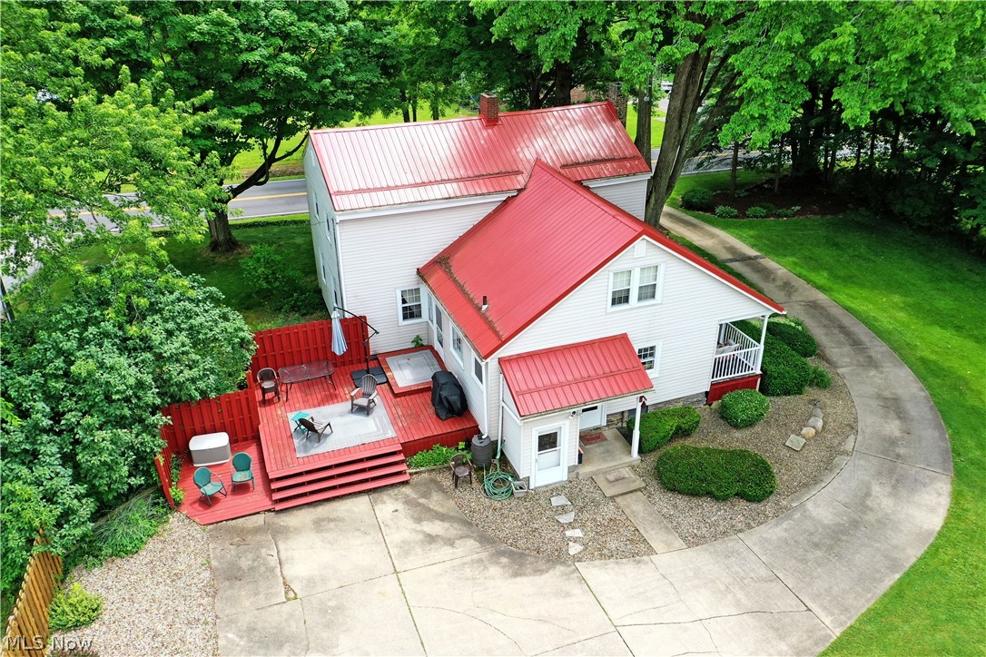 8683 King Graves Road Northeast Warren, OH 44484 - Photo 49 of 50 Property featuring a red metal roof, white siding, and a multi-level red wood deck