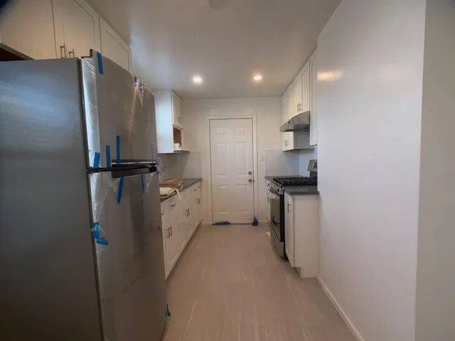 a kitchen with stainless steel appliances a refrigerator and a stove