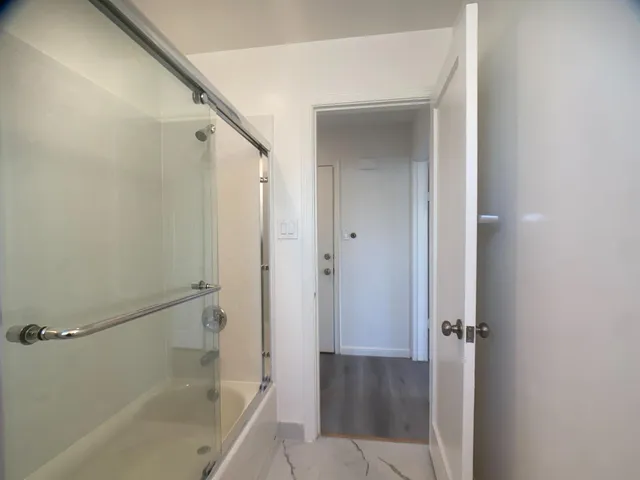 a bathroom with a bathtub and shower