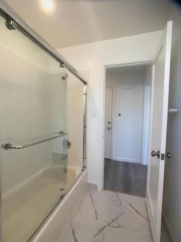 a bathroom with a bathtub and a shower