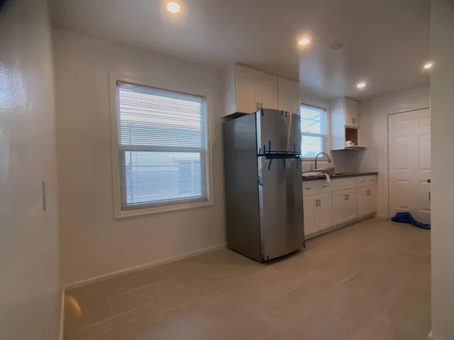 a kitchen with a refrigerator and window
