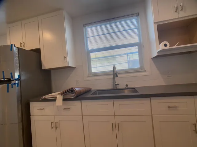 a kitchen with a sink and cabinets