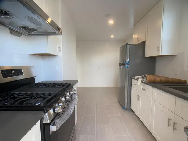 a kitchen with stainless steel appliances granite countertop a stove and a sink