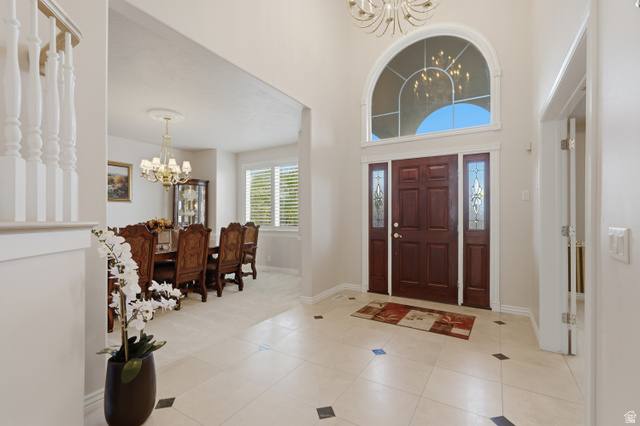 11943 Autumn Ridge Drive East Sandy, UT 84092 - Photo 5 of 59 Foyer with hanging lights, a high ceiling, and light tile patterned floors