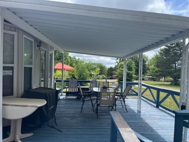 a view of a chairs and table in the balcony