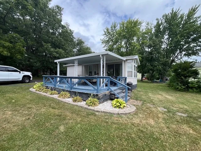 a view of a house with swimming pool and porch