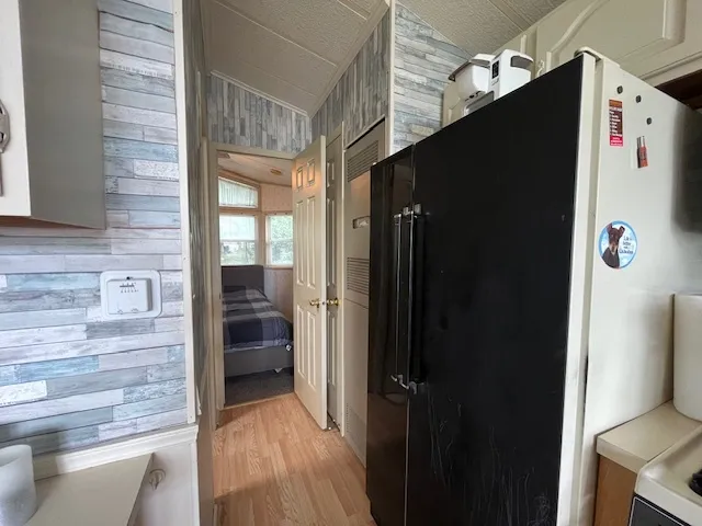 a view of a livingroom with furniture a flat screen tv and a large window