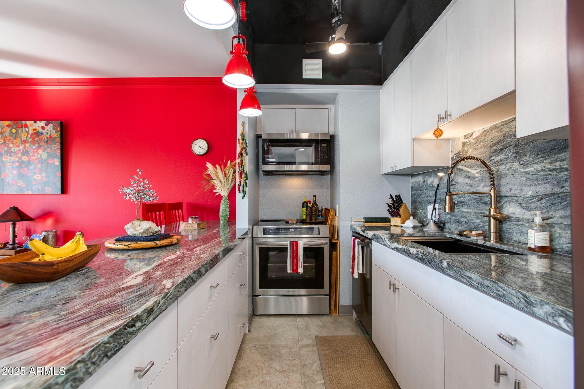 a kitchen with granite countertop stainless steel appliances and counter space