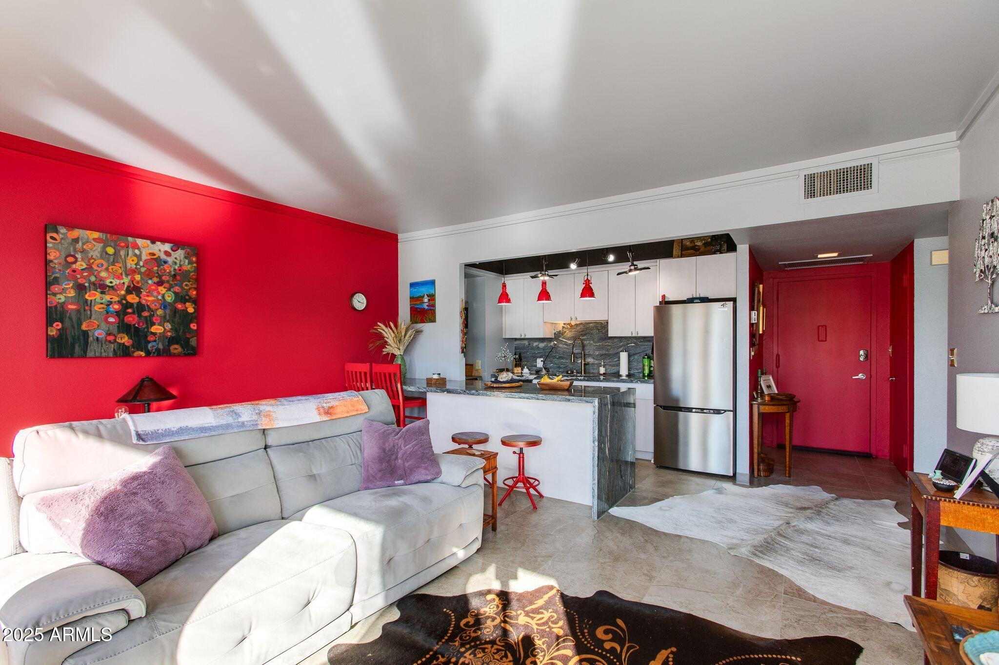 4750 North Central Avenue, Unit 3J Phoenix, AZ 85012 - Photo 3 of 11 a living room with furniture and a flat screen tv