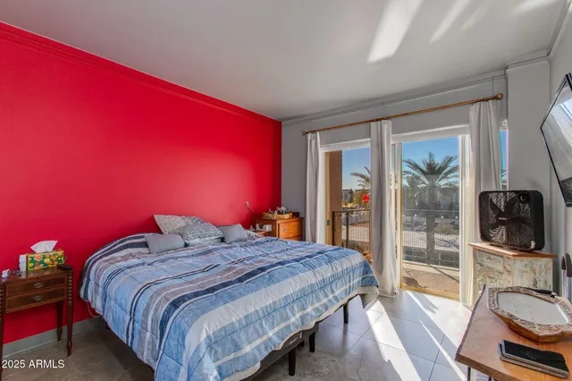 a bedroom with a bed and a flat screen tv