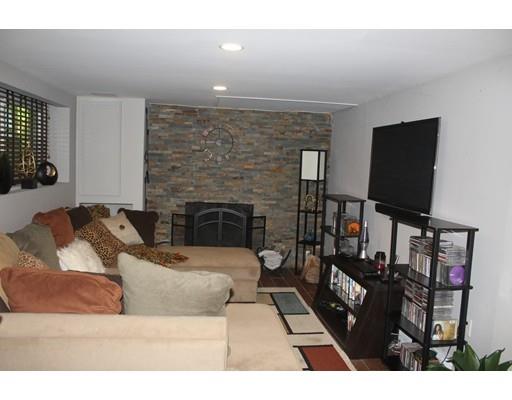 492 Brook Street Framingham, MA 01701 - Photo 12 of 15 a living room with furniture a flat screen tv and a fireplace