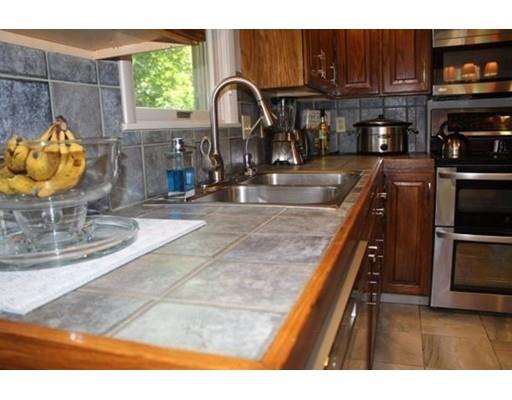 492 Brook Street Framingham, MA 01701 - Photo 3 of 15 a kitchen with a sink a stove and a microwave with granite countertop