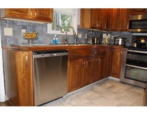 492 Brook Street Framingham, MA 01701 - Photo 4 of 15 a kitchen view with granite countertop a sink dishwasher stove and cabinets