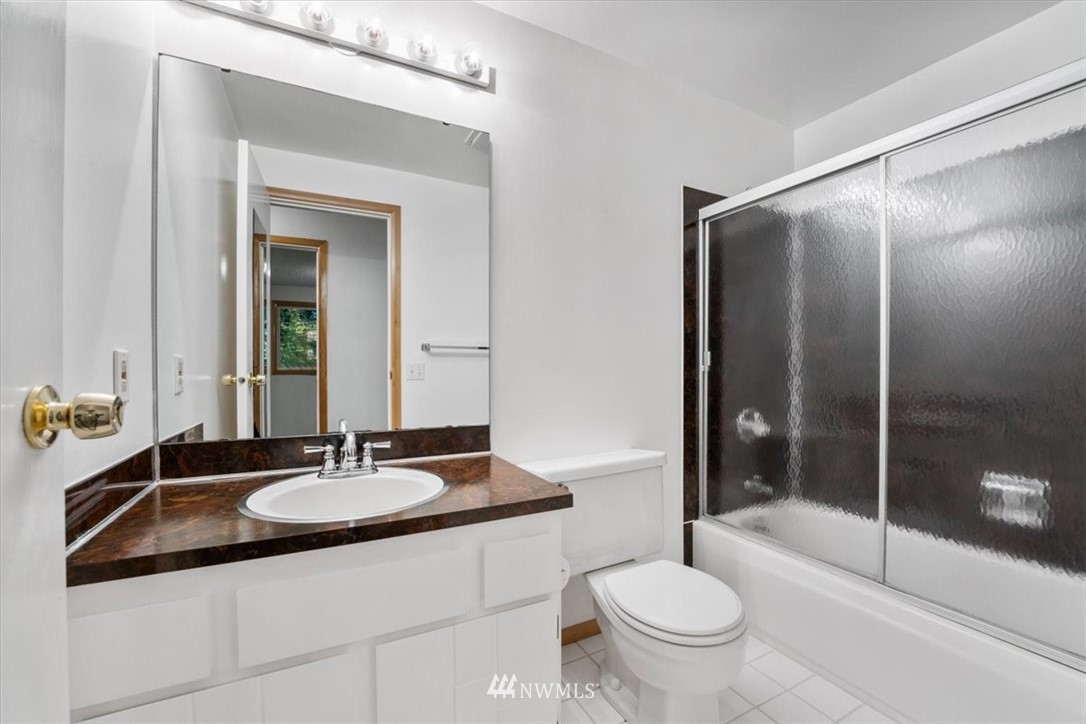 22608 31st Avenue Southeast Bothell, WA 98021 - Photo 14 of 36 a bathroom with a sink toilet and shower