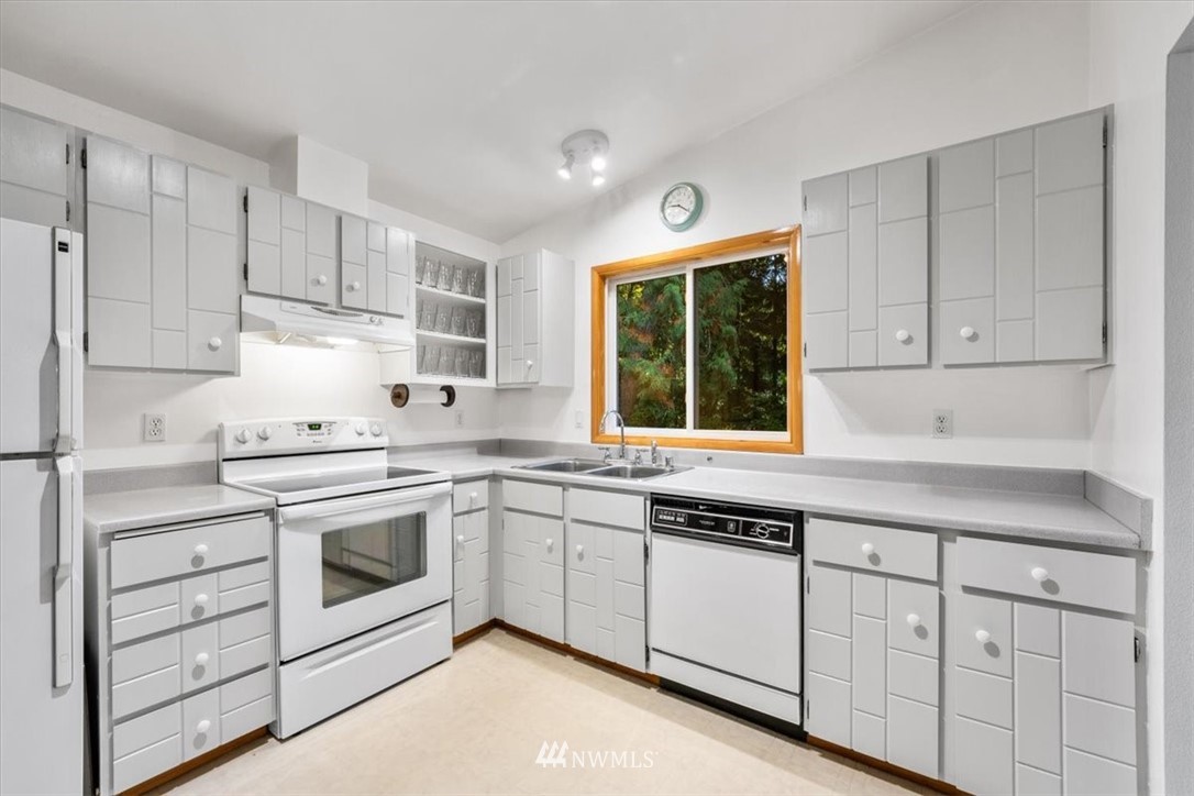 22608 31st Avenue Southeast Bothell, WA 98021 - Photo 4 of 36 a kitchen with white cabinets sink and window
