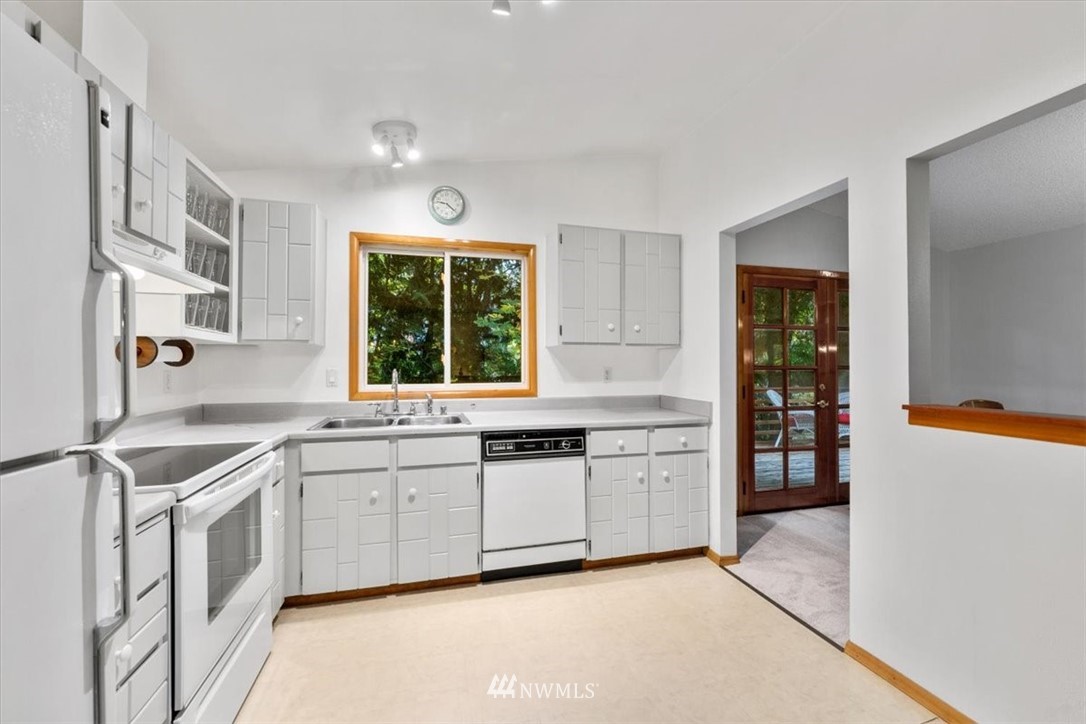 22608 31st Avenue Southeast Bothell, WA 98021 - Photo 6 of 36 a kitchen with a sink stove and cabinets