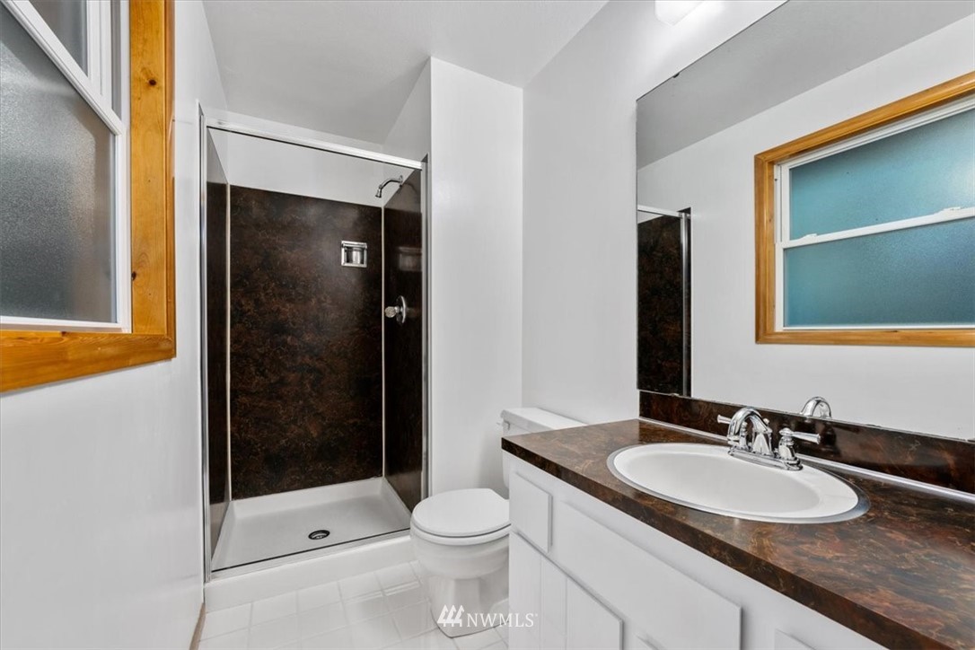 22608 31st Avenue Southeast Bothell, WA 98021 - Photo 10 of 36 a bathroom with a sink a toilet and shower