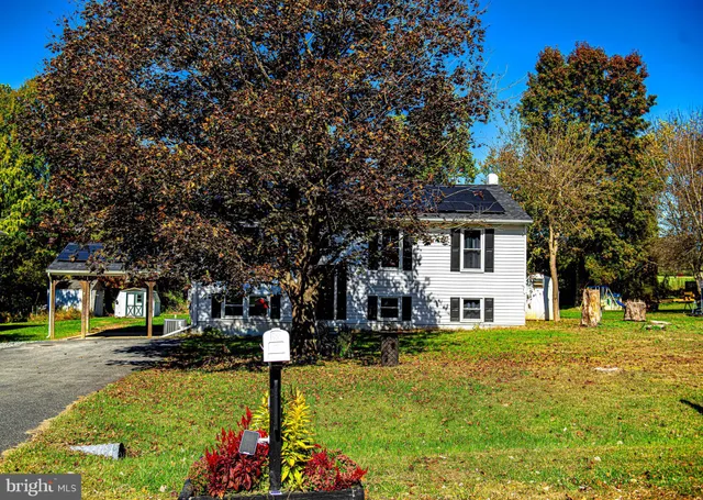 a front view of a house with a yard table and chairs