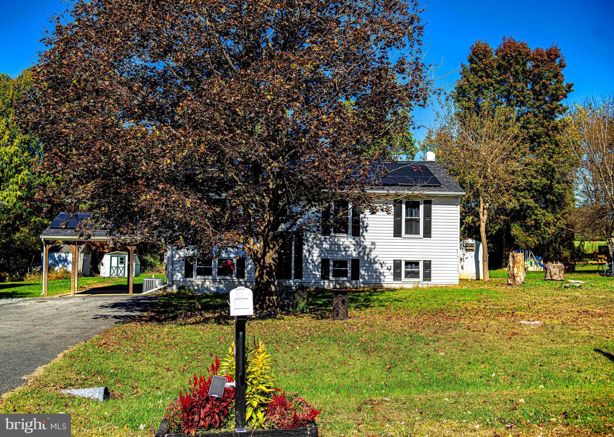 a front view of a house with a yard table and chairs