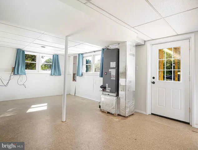 a view of a porch with a table and chairs under an umbrella