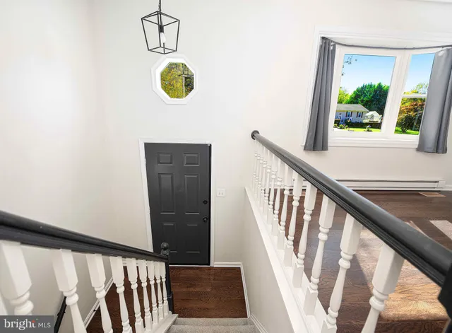 a view of an entryway with wooden floor