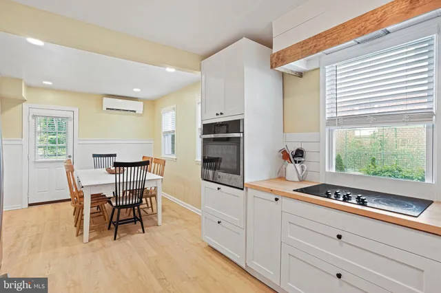 a kitchen with stainless steel appliances granite countertop a sink and a refrigerator