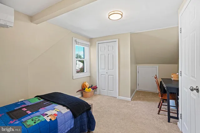 a bedroom with a bed and a window