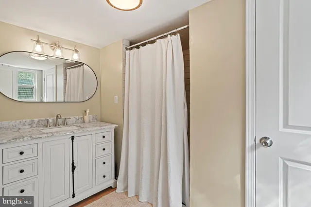 a bathroom with a double vanity sink and mirror