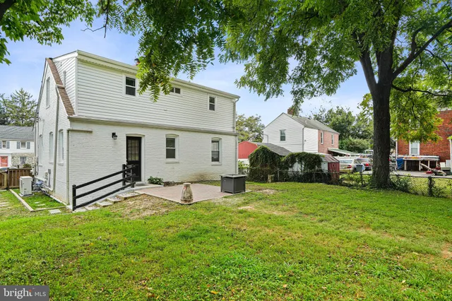 a view of a house with a yard and sitting area