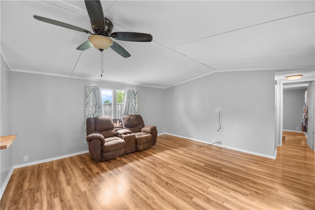 169 West Bagwell Road Liberty, SC 29657 - Photo 9 of 29 A well-lit room showcasing rich hardwood flooring and a functional ceiling fan.