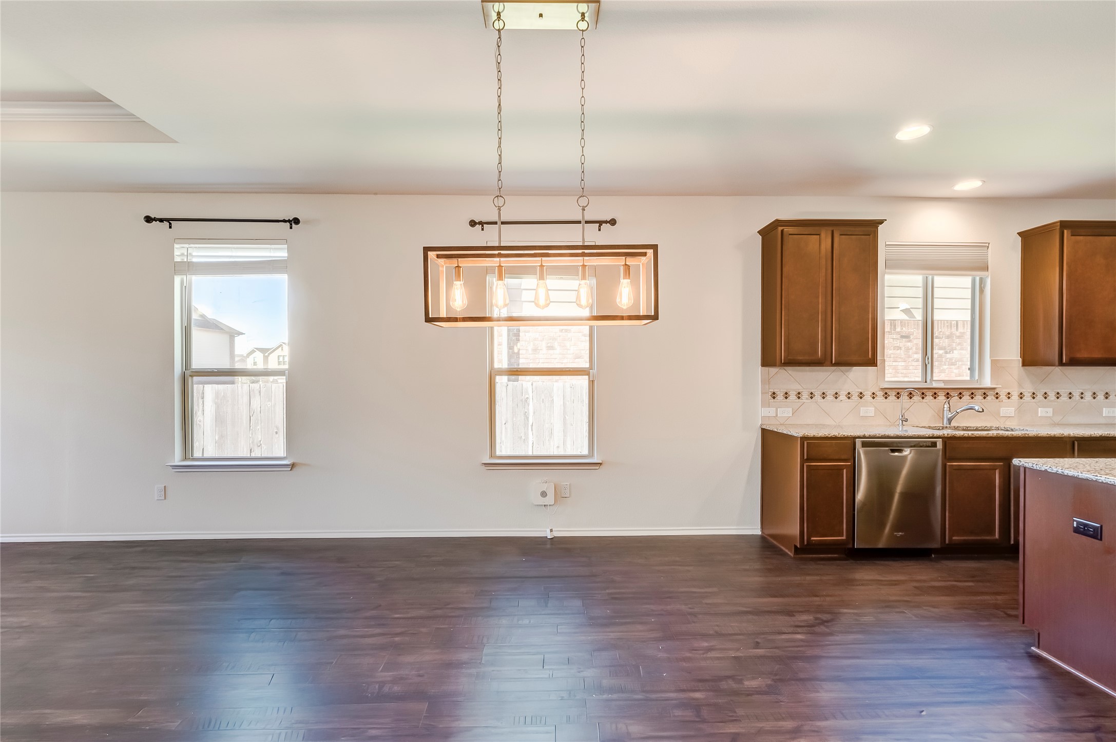 11617 Amber Stream Lane Manor, TX 78653 - Photo 12 of 39 a view of an empty room with wooden floor and a window