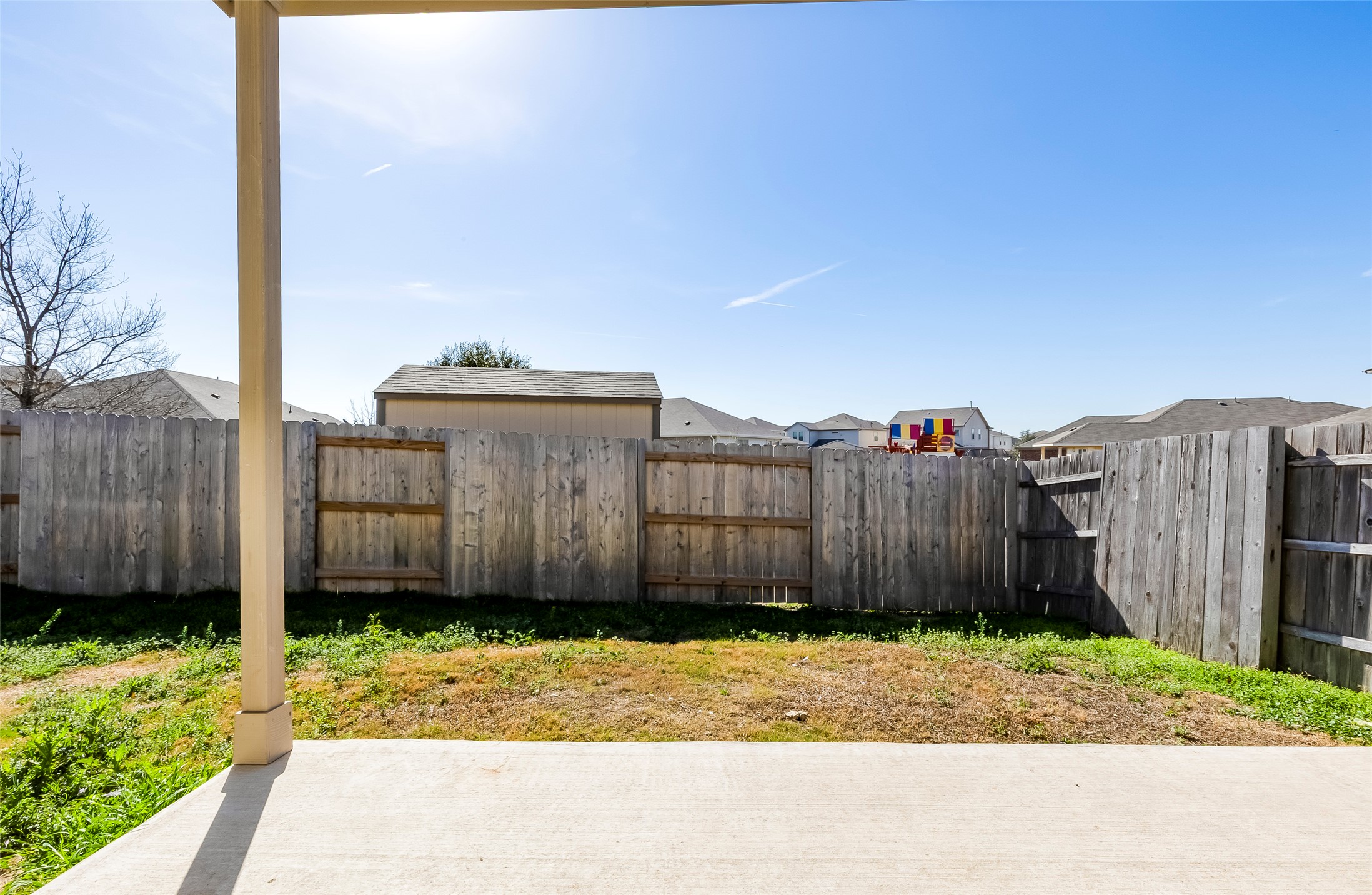 11617 Amber Stream Lane Manor, TX 78653 - Photo 22 of 39 a view of a small yard with wooden fence
