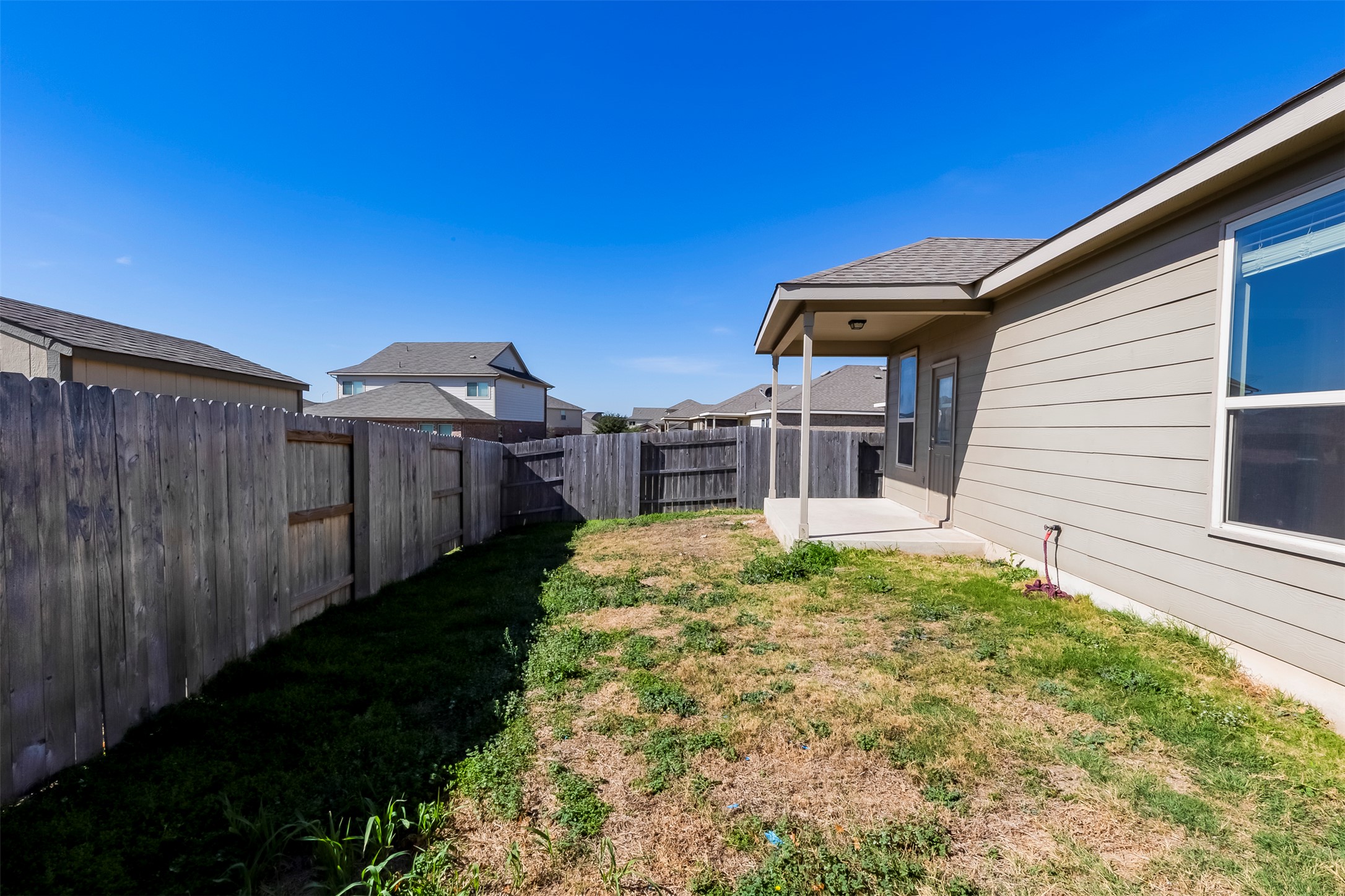 11617 Amber Stream Lane Manor, TX 78653 - Photo 26 of 39 a house view with a backyard space