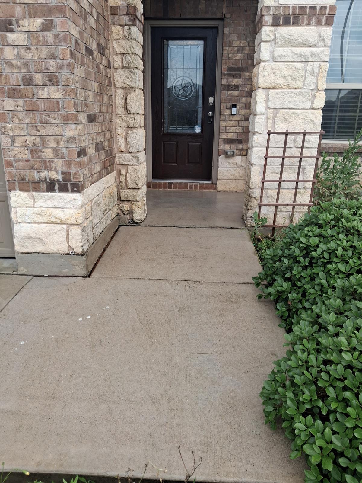 11617 Amber Stream Lane Manor, TX 78653 - Photo 4 of 39 Inviting entryway featuring a dark wood door with decorative glass inlay, framed by brick and stone veneer siding